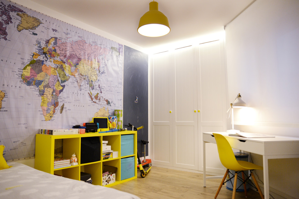 Contemporary children’s room for boys in Other with blue walls, light hardwood flooring and brown floors.
