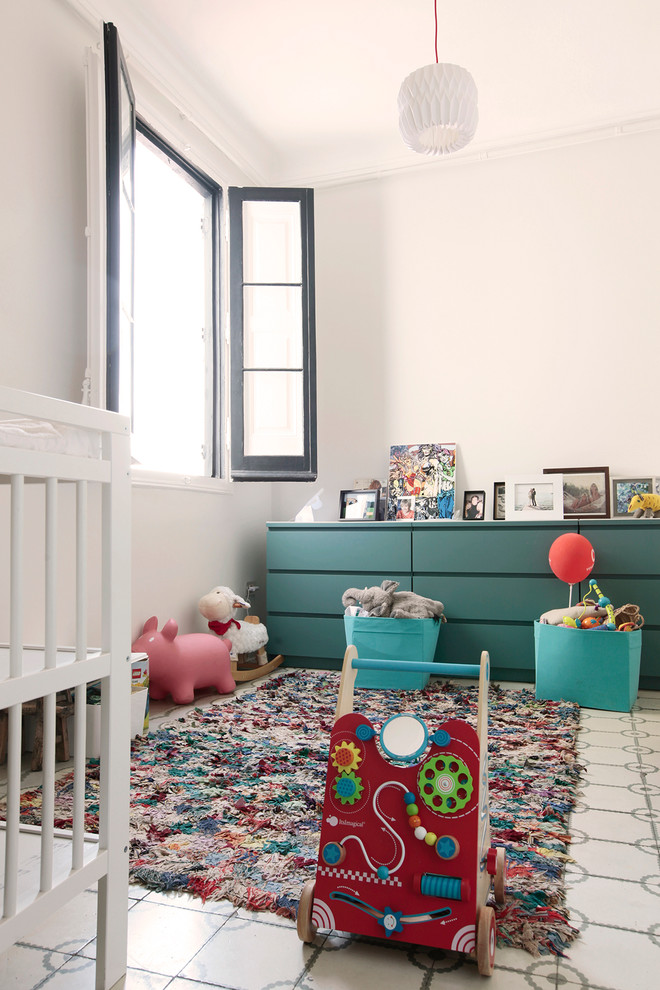 This is an example of a medium sized classic gender neutral toddler’s room in Barcelona.