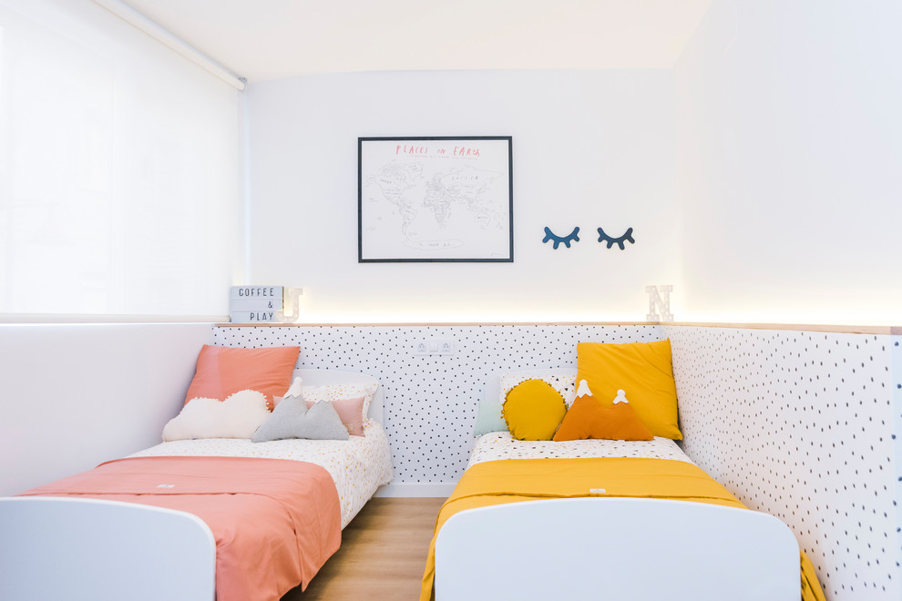 Diseño de dormitorio infantil de 1 a 3 años nórdico de tamaño medio con paredes blancas, suelo de madera en tonos medios y suelo marrón