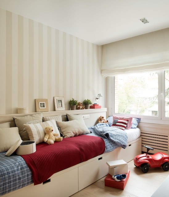 Medium sized contemporary children’s room for boys in Barcelona with multi-coloured walls and medium hardwood flooring.