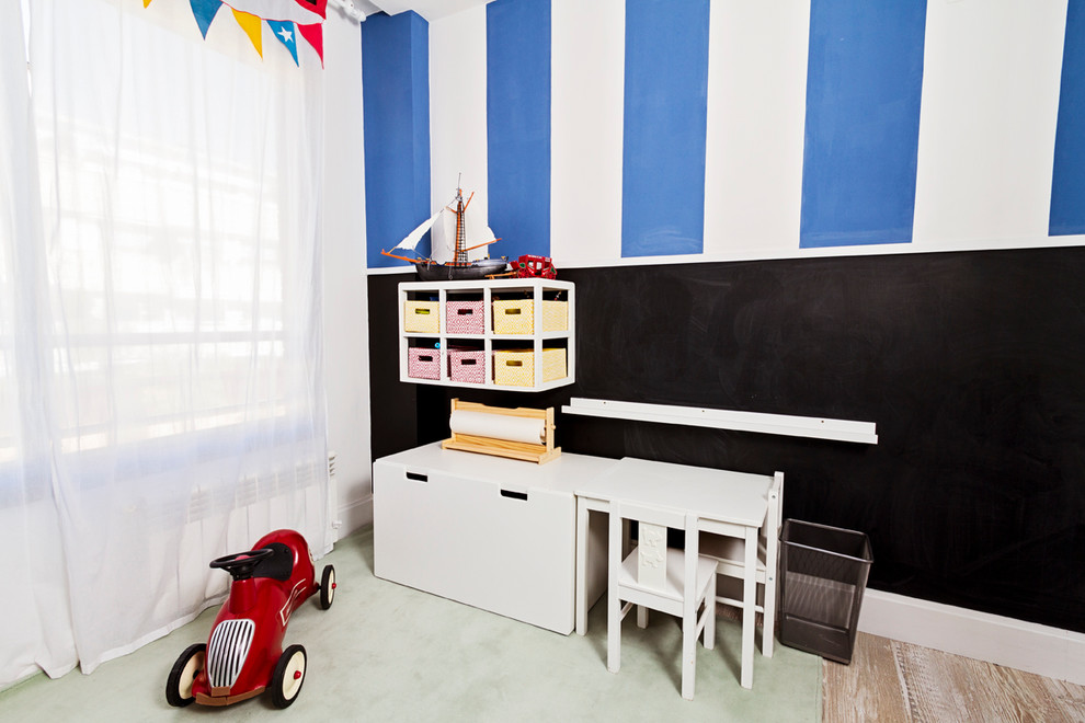 This is an example of a medium sized traditional kids' bedroom for boys in Madrid with multi-coloured walls and medium hardwood flooring.
