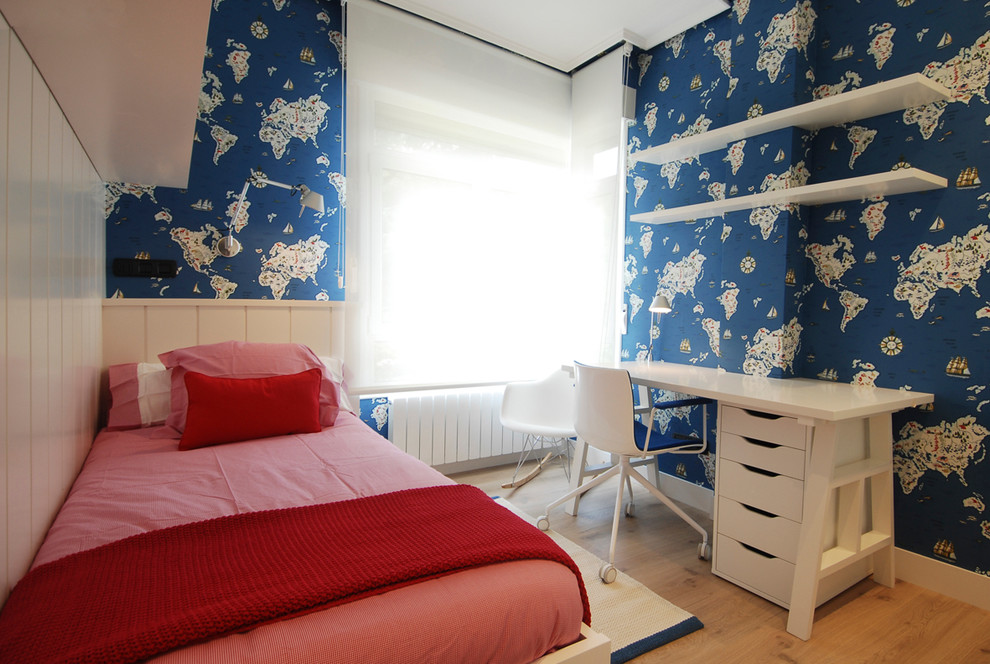 Kids' room - mid-sized transitional boy medium tone wood floor kids' room idea in Bilbao with blue walls