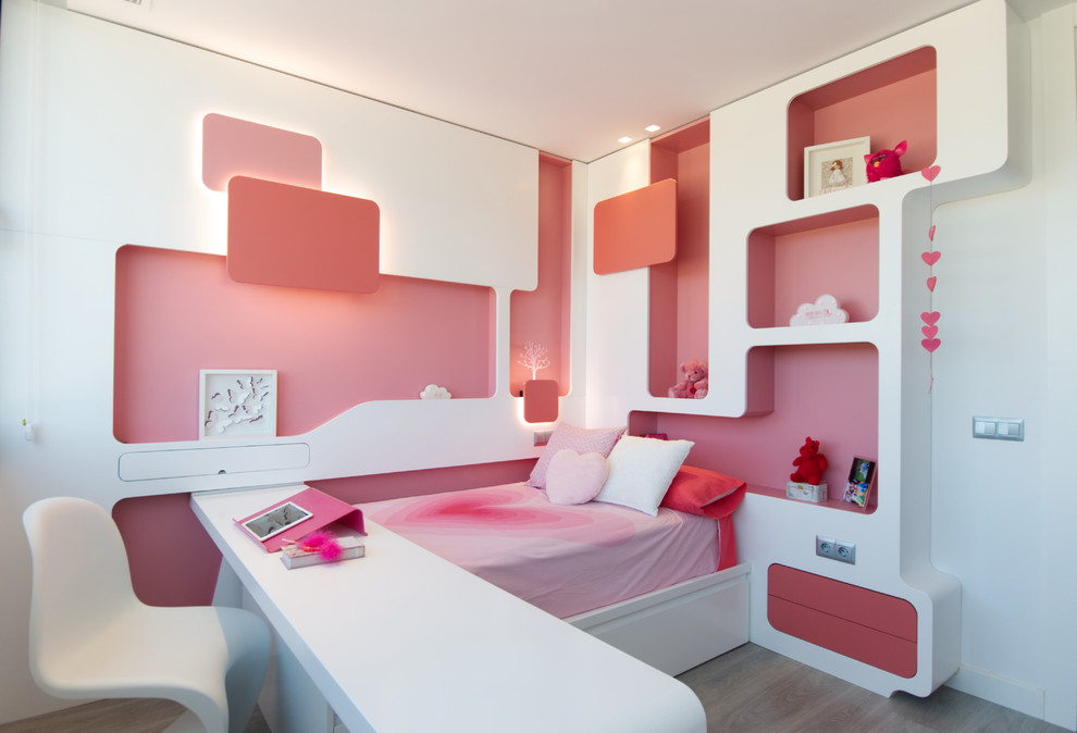 This is an example of a contemporary children’s room for girls in Madrid with white walls and grey floors.