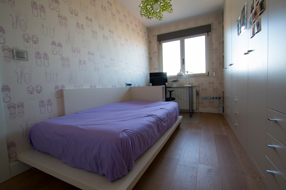 This is an example of a medium sized classic teen’s room for girls in Other with multi-coloured walls and medium hardwood flooring.