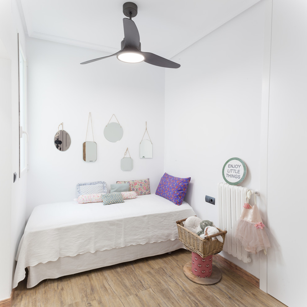 Example of an island style girl beige floor kids' room design in Madrid with white walls