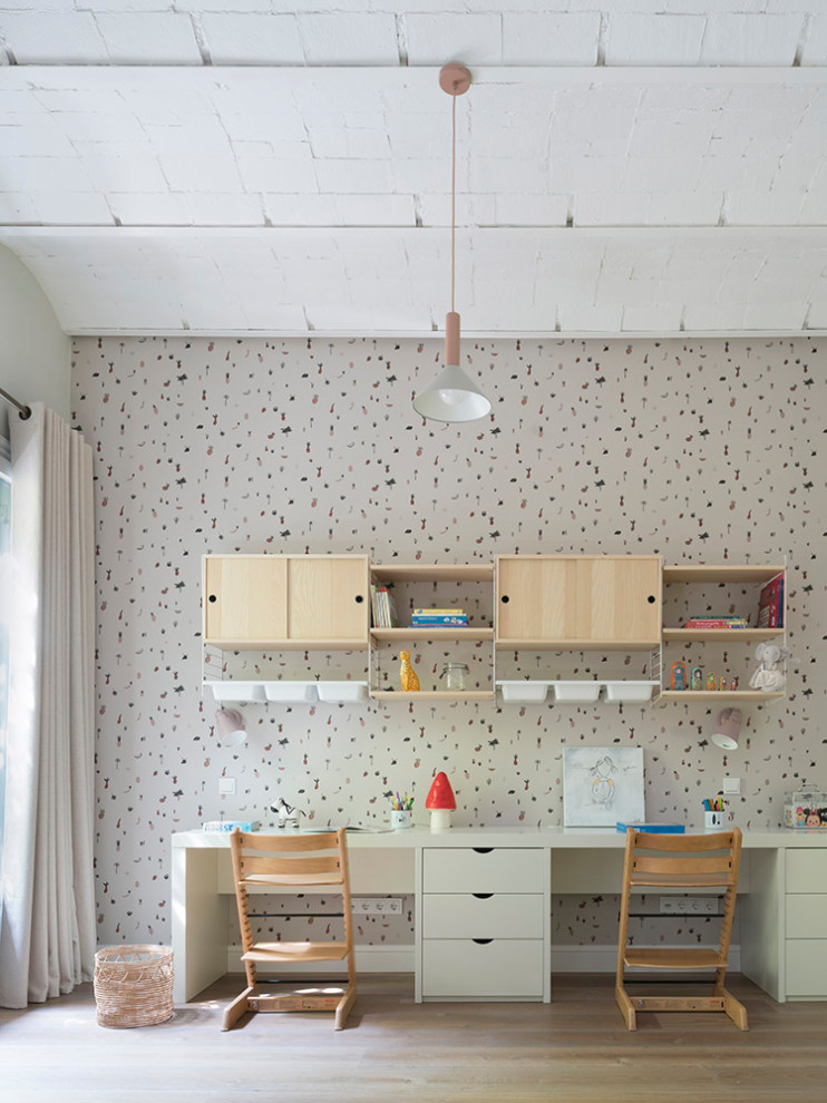 Photo of a large shabby-chic style children’s room for girls in Barcelona with multi-coloured walls, medium hardwood flooring and brown floors.
