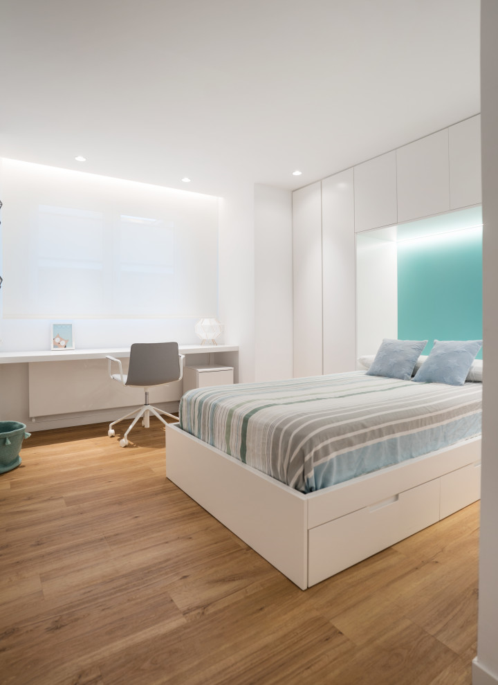 Modelo de dormitorio infantil actual grande con paredes blancas, suelo de madera en tonos medios y suelo beige