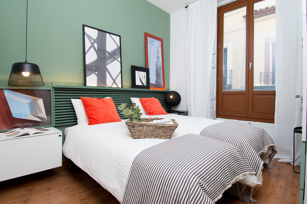 Inspiration for a mediterranean guest medium tone wood floor bedroom remodel in Madrid with green walls and no fireplace