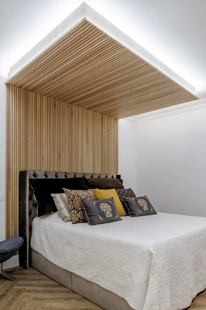 This is an example of a contemporary bedroom in Other with white walls, medium hardwood flooring, a wooden fireplace surround, brown floors and wood walls.