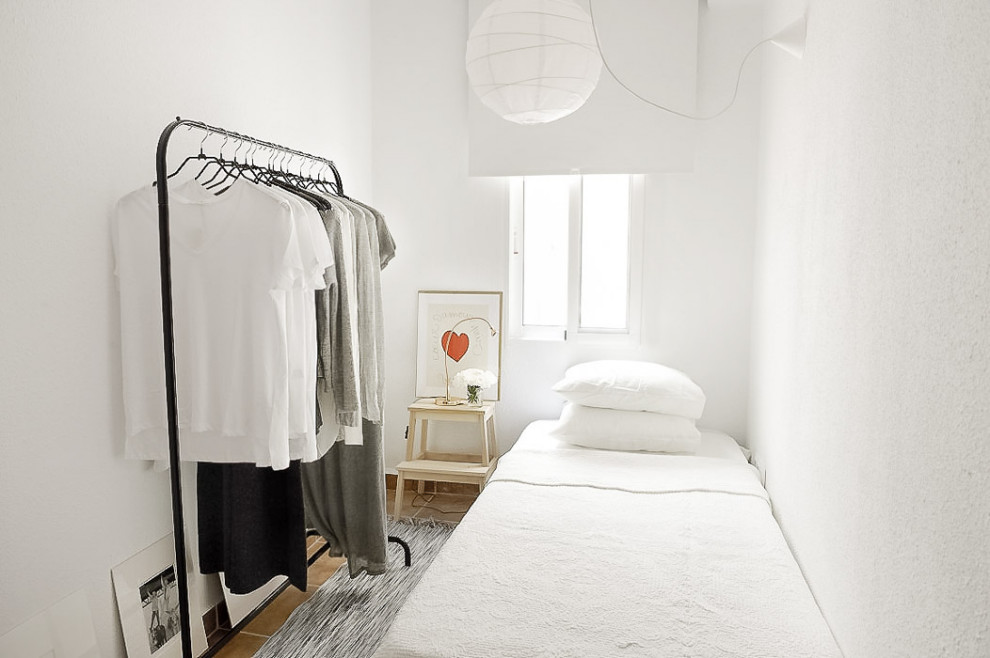 Imagen de habitación de invitados rural pequeña con paredes blancas, suelo de baldosas de terracota y suelo beige