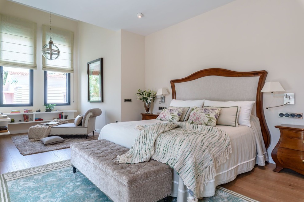 Foto de dormitorio principal clásico renovado grande sin chimenea con paredes beige, suelo de madera en tonos medios y suelo marrón