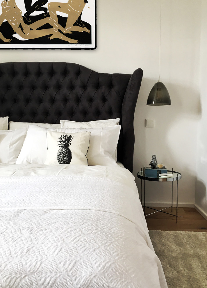 Bedroom - small scandinavian guest medium tone wood floor bedroom idea in Barcelona with white walls