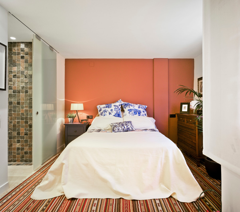 Example of a mid-sized eclectic master bedroom design in Other with no fireplace and orange walls