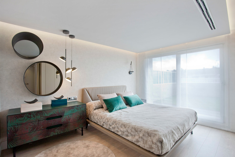 This is an example of a medium sized contemporary master bedroom in Other with light hardwood flooring, beige walls and beige floors.