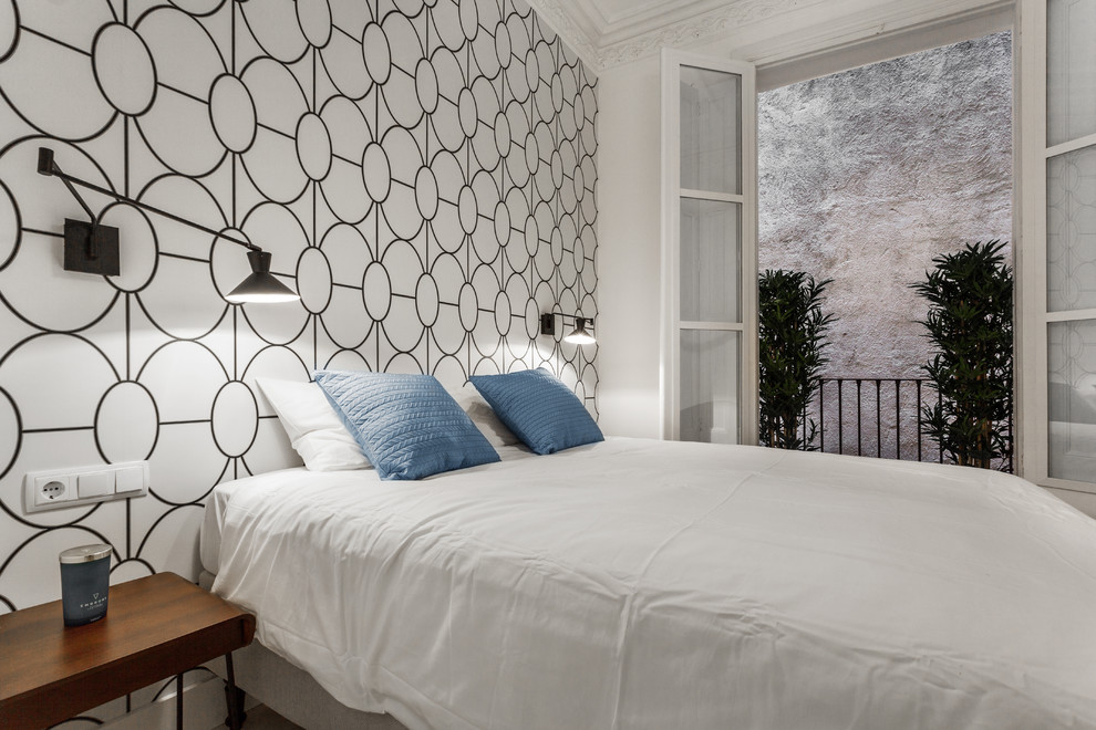 This is an example of a medium sized scandi master bedroom in Barcelona with white walls.