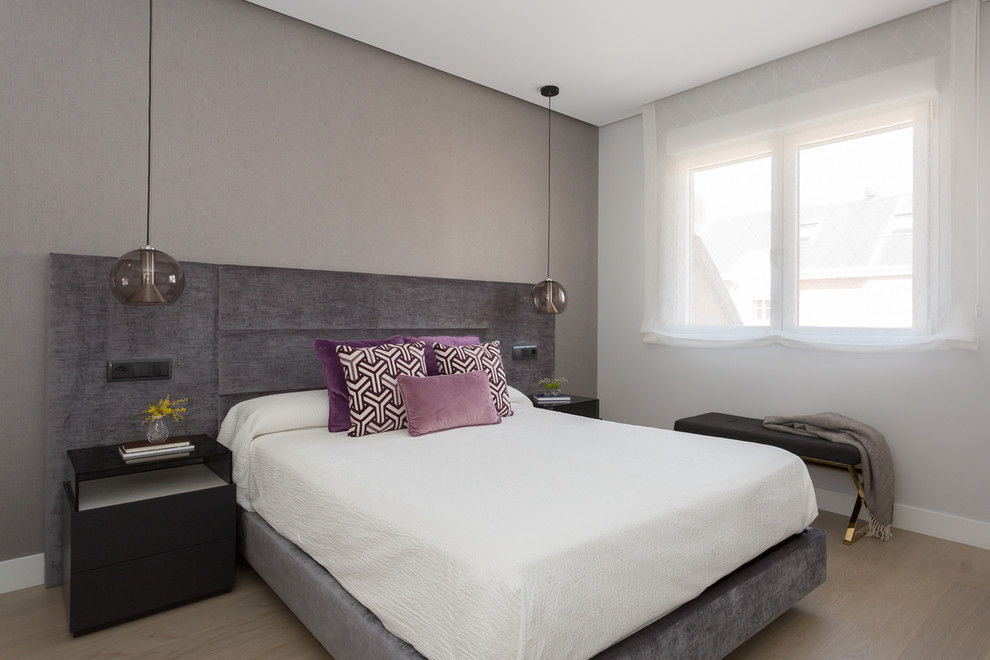 マドリードにあるコンテンポラリースタイルのおしゃれな主寝室 (グレーの壁、淡色無垢フローリング、暖炉なし、ベージュの床) のレイアウト