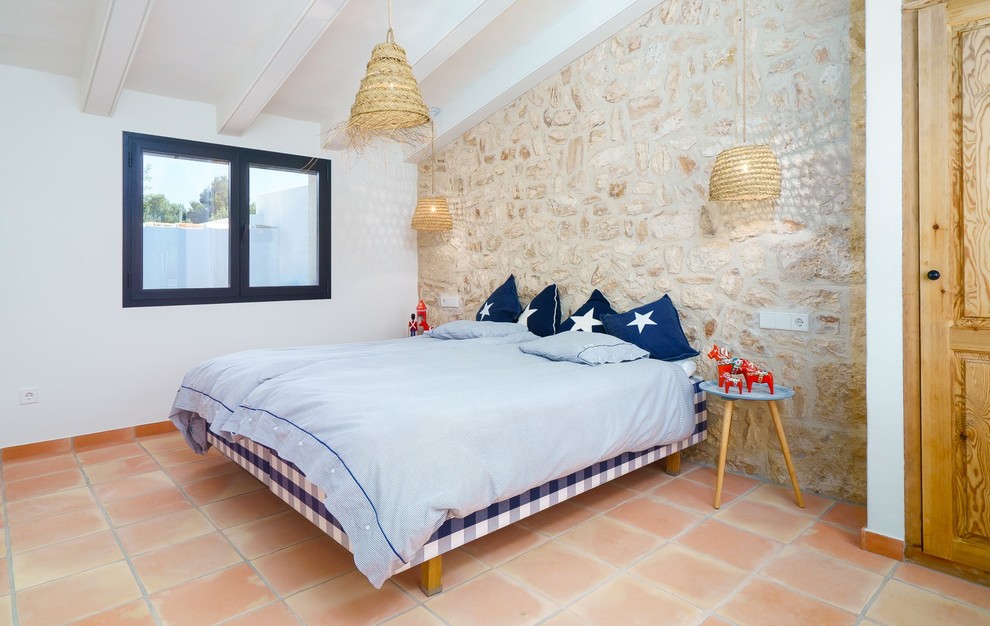 Inspiration for a mediterranean bedroom in Alicante-Costa Blanca with beige walls, terracotta flooring and orange floors.