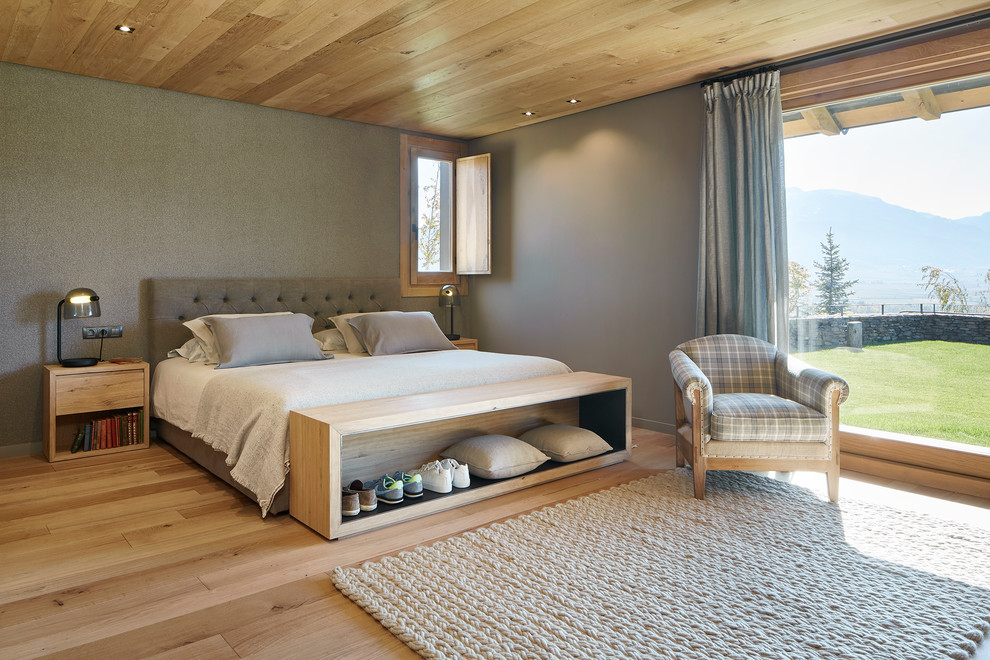 Großes Landhausstil Hauptschlafzimmer mit hellem Holzboden, grauer Wandfarbe und braunem Boden in Sonstige