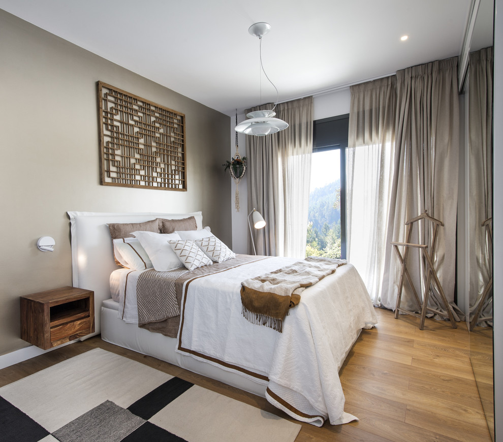 Medium sized scandi master and grey and silver bedroom in Barcelona with beige walls, no fireplace and light hardwood flooring.