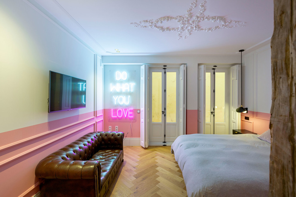 Photo of a contemporary bedroom in Other with pink walls, light hardwood flooring and brown floors.
