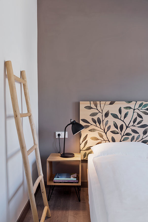 Photo of a medium sized scandi guest bedroom in Alicante-Costa Blanca with brown walls, laminate floors and grey floors.