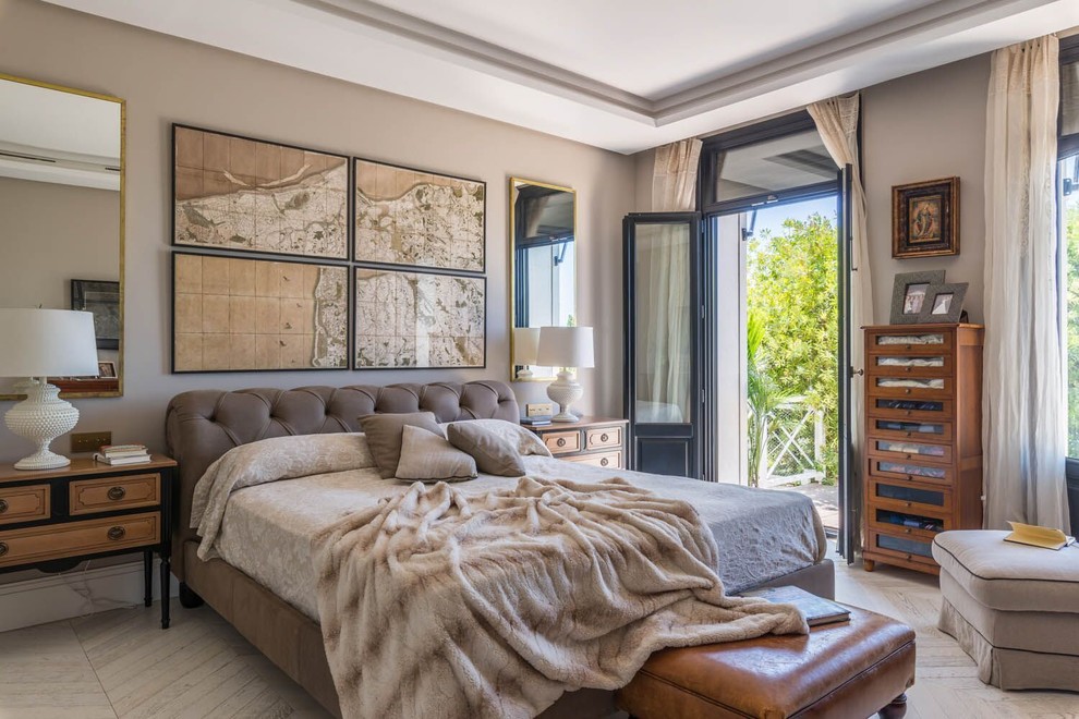 Example of a large transitional master light wood floor and beige floor bedroom design in Malaga with beige walls and no fireplace