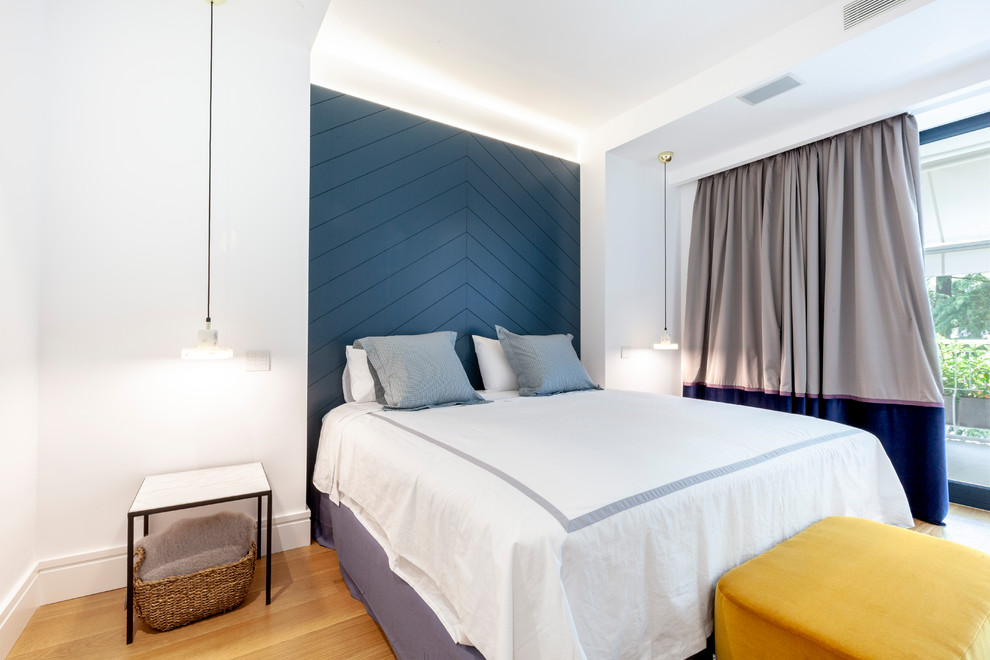 他の地域にあるコンテンポラリースタイルのおしゃれな客用寝室 (白い壁、無垢フローリング、暖炉なし)