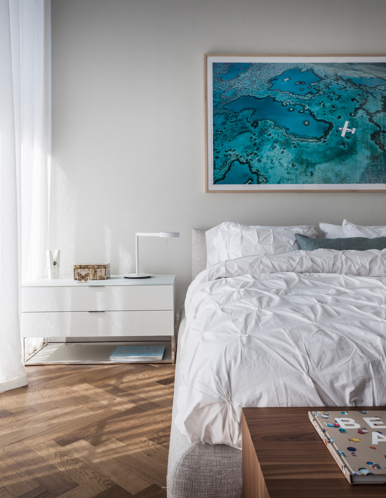 Bedroom - contemporary medium tone wood floor and brown floor bedroom idea in Miami with white walls