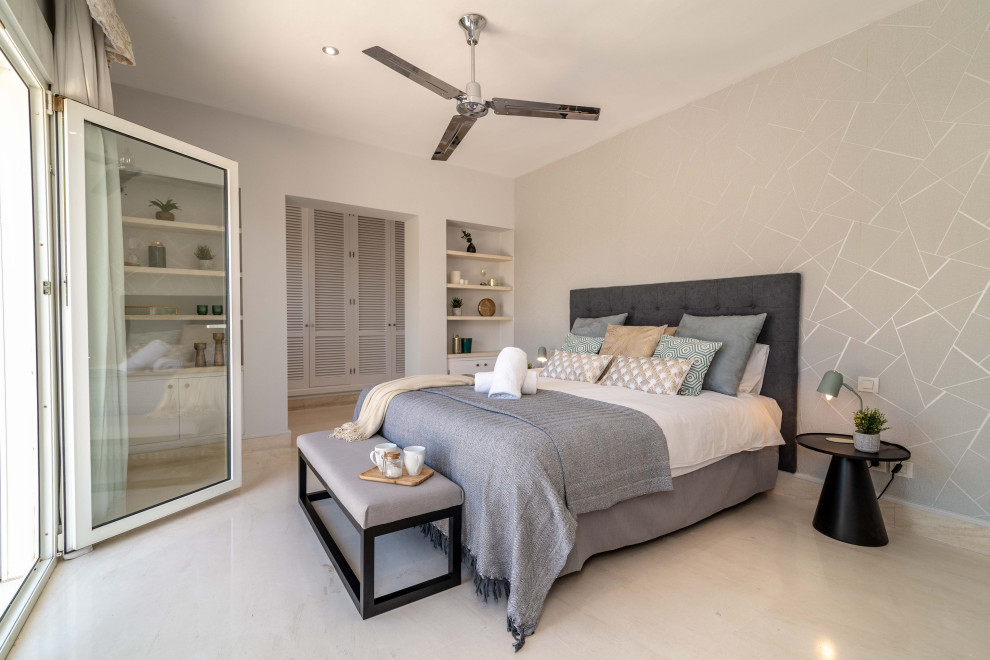 Photo of an expansive contemporary guest bedroom in Malaga with white walls, no fireplace, beige floors and wallpapered walls.