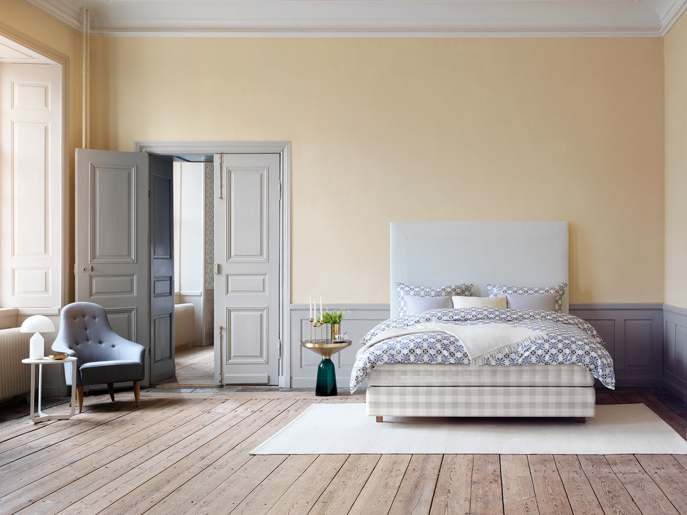 バレンシアにある広い北欧スタイルのおしゃれな主寝室 (黄色い壁、無垢フローリング、暖炉なし) のレイアウト