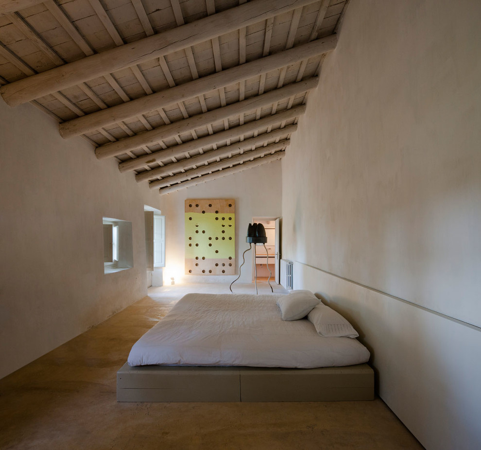 This is an example of an expansive contemporary master bedroom in Barcelona with white walls and no fireplace.