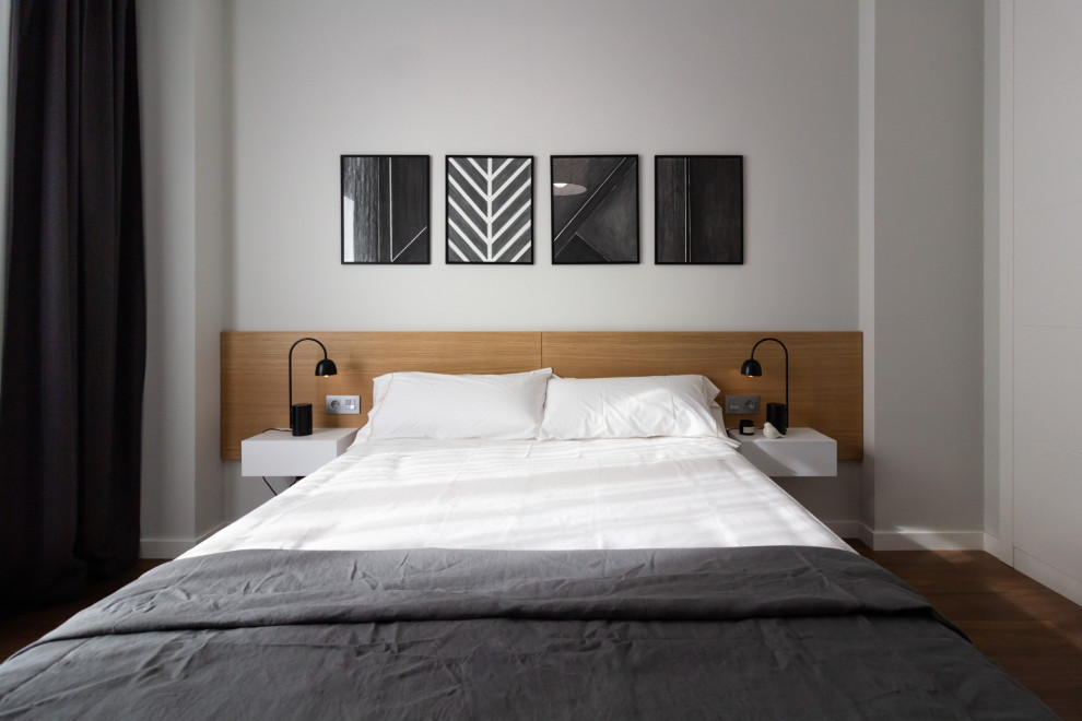 Mid-sized trendy medium tone wood floor and beige floor bedroom photo in Other with gray walls