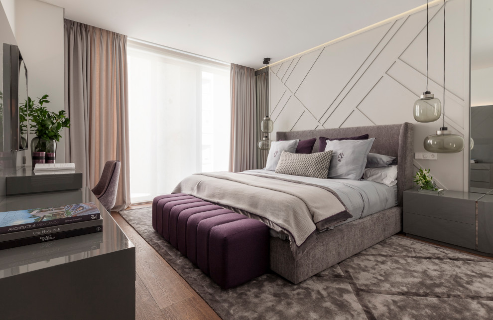 Inspiration for a large contemporary master and grey and brown bedroom in Madrid with grey walls, medium hardwood flooring, no fireplace and brown floors.
