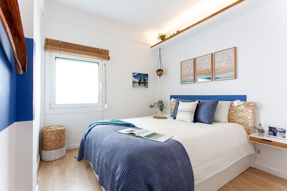 Mid-sized beach style master light wood floor and brown floor bedroom photo in Barcelona with white walls and no fireplace