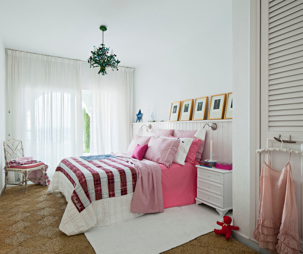 This is an example of a medium sized eclectic master bedroom in Madrid with white walls and no fireplace.