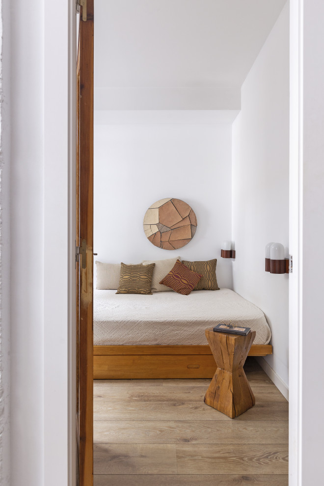 Imagen de dormitorio actual con paredes blancas, suelo de madera clara y suelo beige