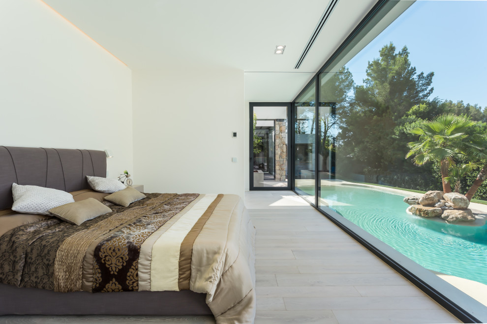 Ejemplo de dormitorio moderno con paredes blancas, suelo de madera clara y suelo beige