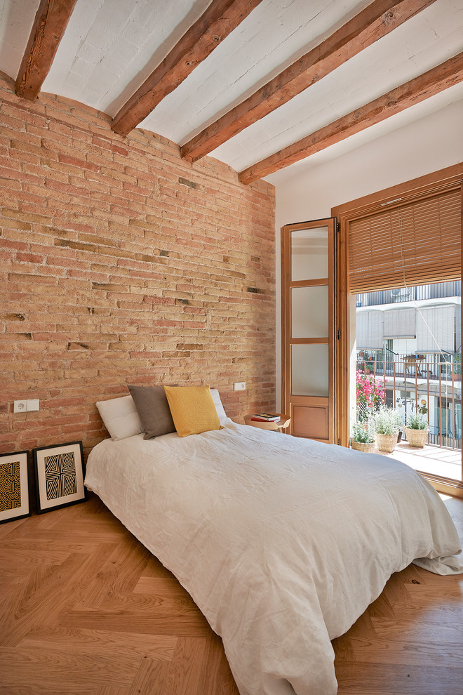 This is an example of a mediterranean master bedroom in Barcelona with medium hardwood flooring.