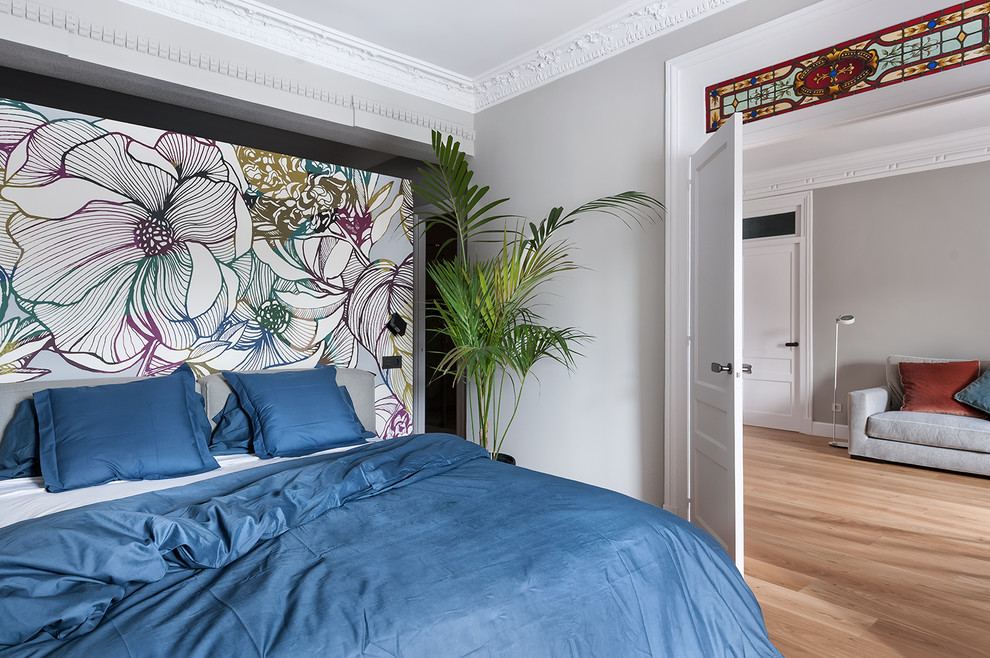 Ejemplo de dormitorio ecléctico de tamaño medio con paredes grises, suelo de madera en tonos medios y suelo marrón