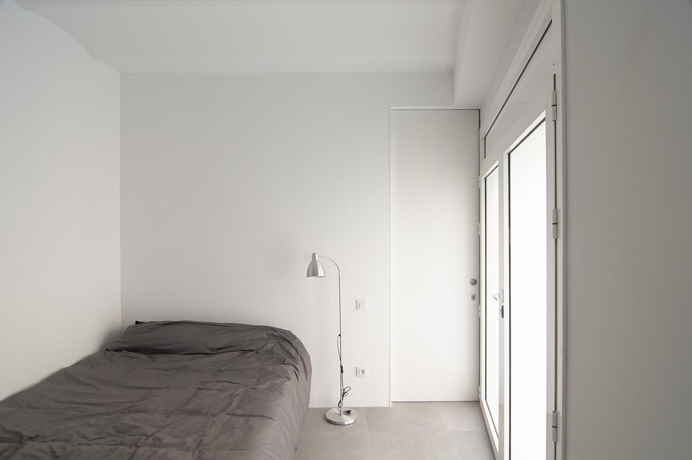 Diseño de dormitorio principal actual pequeño sin chimenea con paredes blancas y suelo de baldosas de cerámica