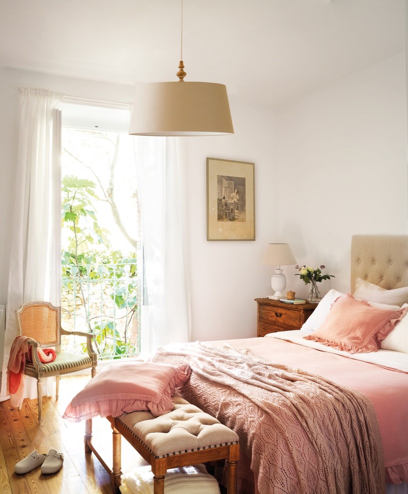 Design ideas for a medium sized vintage master bedroom in Madrid with white walls.