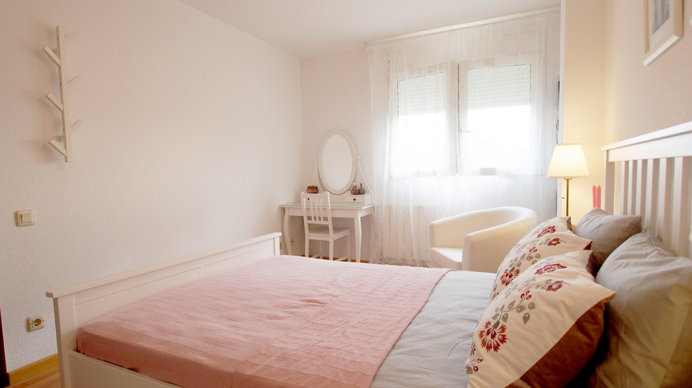 Ejemplo de dormitorio principal romántico grande con paredes blancas, suelo de madera clara y suelo marrón
