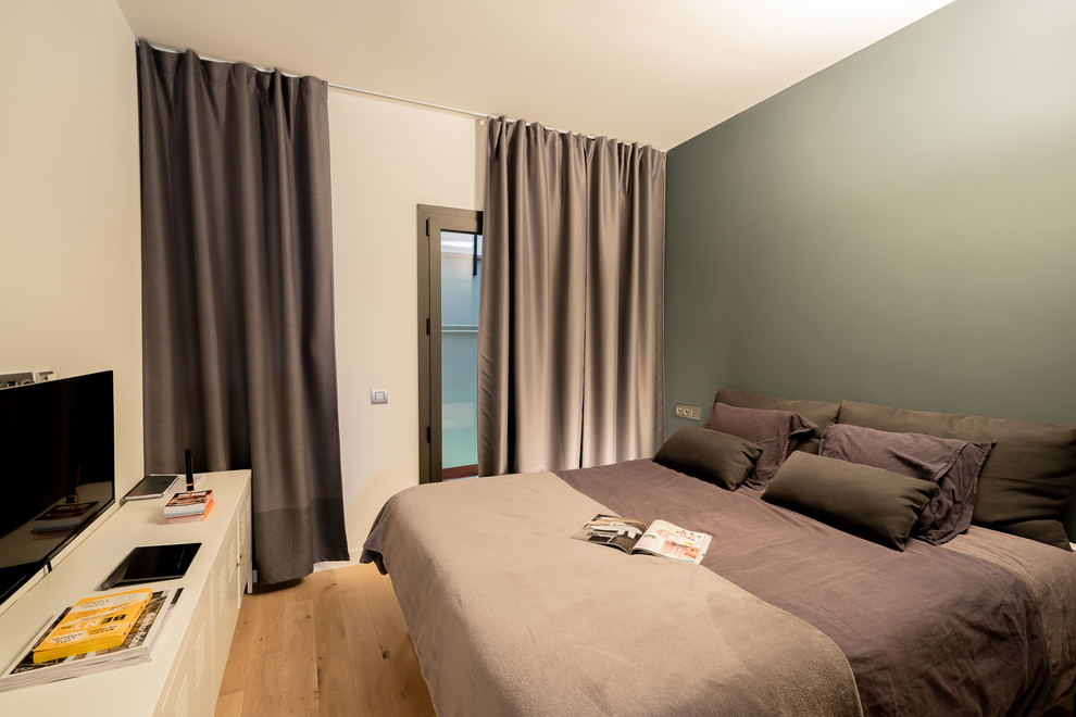 Ispirazione per una camera da letto minimalista con parquet chiaro