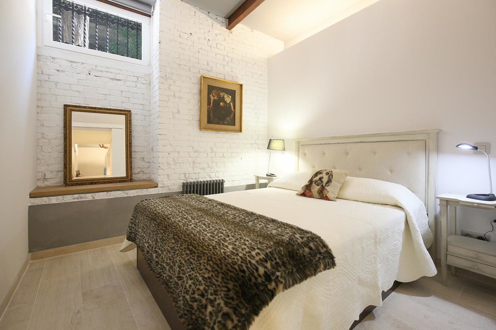 Medium sized urban master bedroom in Madrid with white walls and no fireplace.