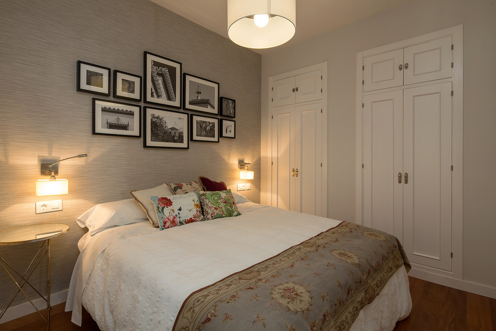 Ejemplo de dormitorio principal moderno de tamaño medio con paredes grises y suelo de madera en tonos medios