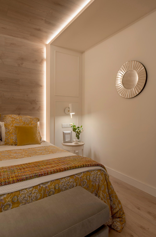 Modelo de dormitorio principal clásico renovado grande sin chimenea con paredes beige, suelo laminado y suelo beige