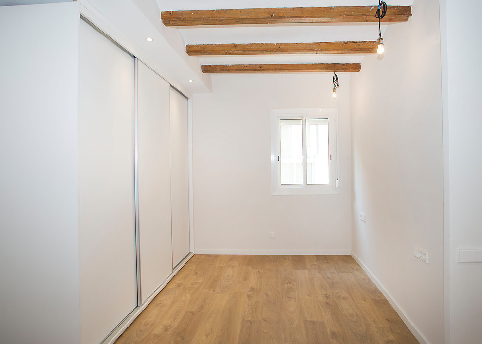 Inspiration for a mid-sized contemporary master medium tone wood floor and brown floor bedroom remodel in Barcelona with white walls and no fireplace
