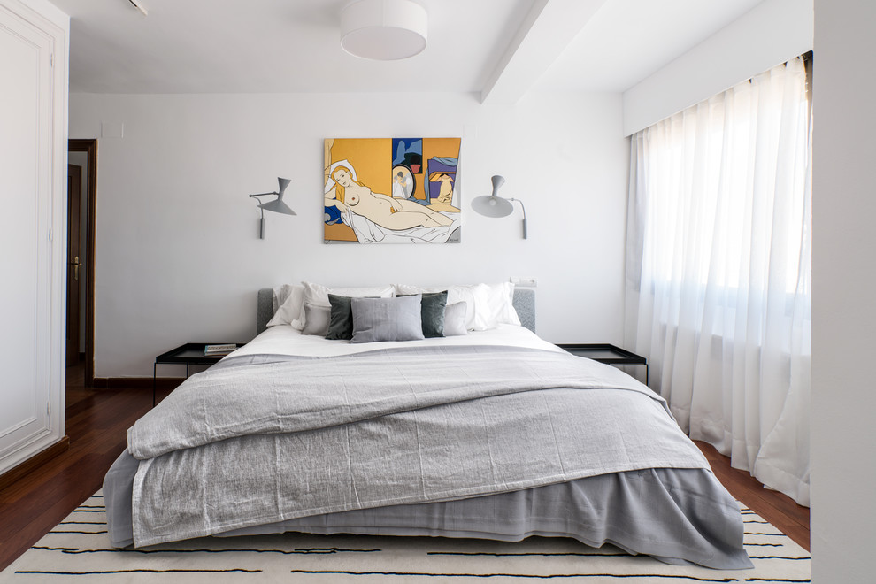 Inspiration for a large modern master dark wood floor and brown floor bedroom remodel in Other with white walls