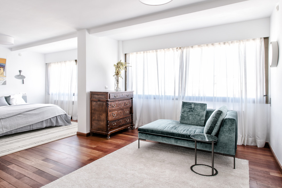 Example of a large trendy master dark wood floor and brown floor bedroom design in Other with white walls