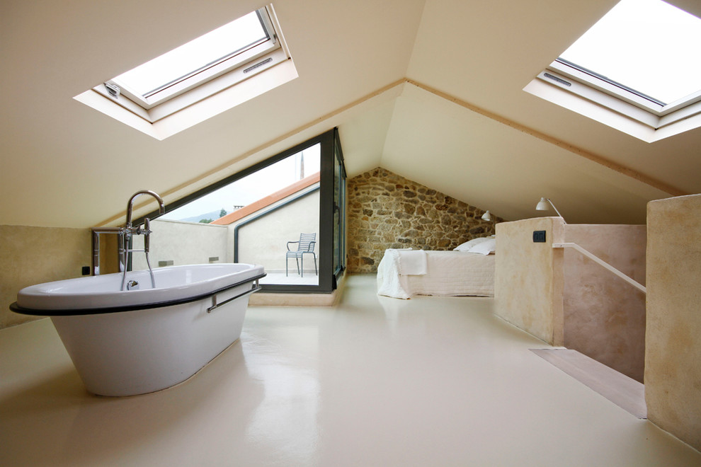Inspiration for a huge rustic loft-style bedroom remodel in Barcelona with no fireplace and beige walls